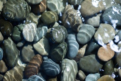 Colorful pebbles under clear water