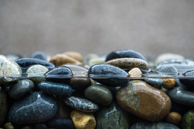 Colorful pebbles under clear water