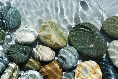 Colorful pebbles under shallow water