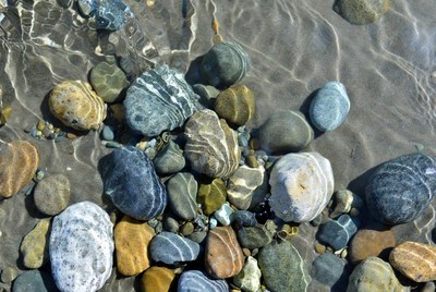 Colorful pebbles under shallow water