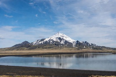 Snow-capped mountain reflecting in lake