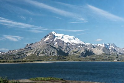 Snow-capped mountain by lake