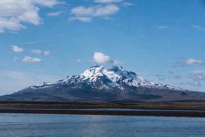 Snowy mountain reflecting in lake