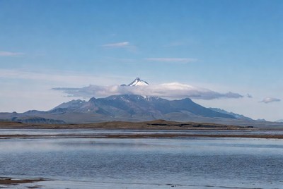 Snow-capped mountain over reflective lake