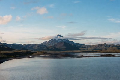 Snow-capped mountain over reflective lake