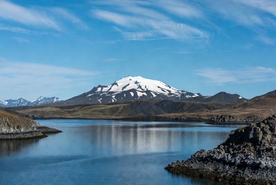 Snow-capped mountain reflecting in lake