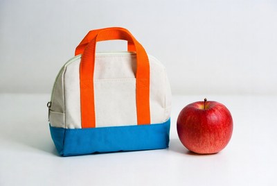 Orange-handled lunch bag with red apple