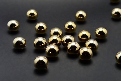 Shiny gold balls on black background
