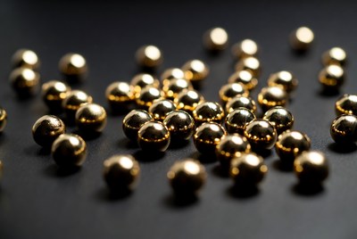 Shiny gold ball bearings scattered