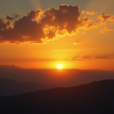 Sunset over mountains with clouds