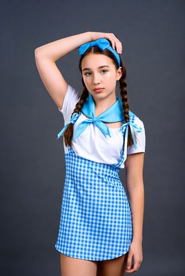 Girl in blue gingham pinafore dress
