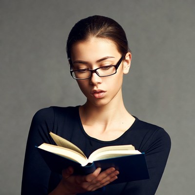 Woman reading book in glasses