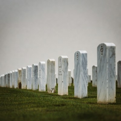 Rows of white gravestones in cemetery