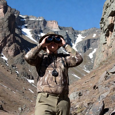 Man using binoculars in mountains