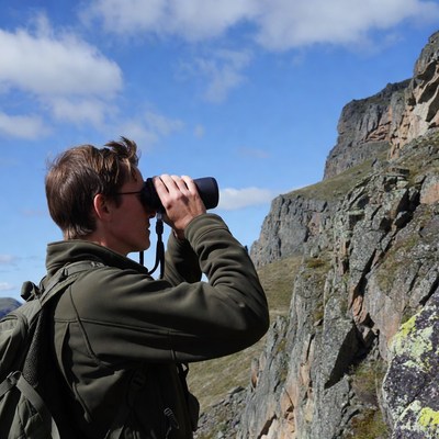 Man using binoculars in mountains