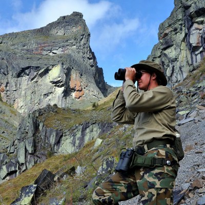 Man using binoculars in mountains