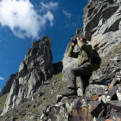 Man using binoculars on mountain