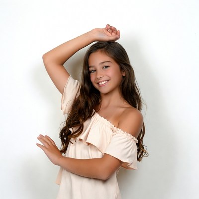 Smiling girl posing with arms raised