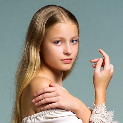 Blonde girl posing on blue background