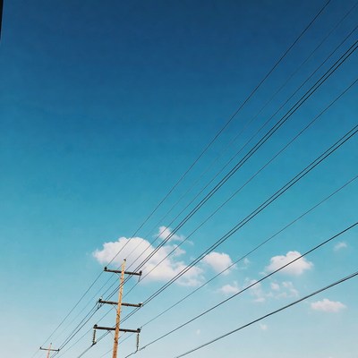 Utility Poles with Wires Against Blue Sky