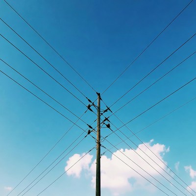 Utility Pole with Wires Against Blue Sky
