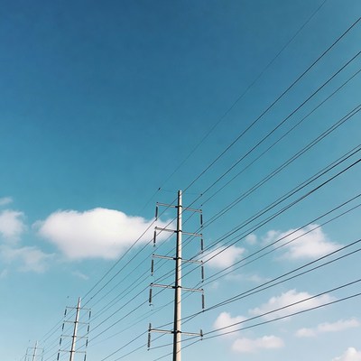 Electricity Pylons Against Blue Sky