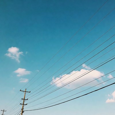 Utility Poles with Wires Against Blue Sky