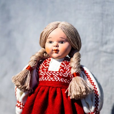 Blonde doll in red folk dress