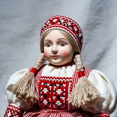 Blonde girl doll in red folk dress