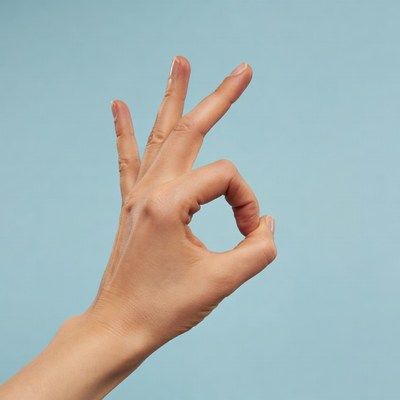 Woman's hand making OK sign