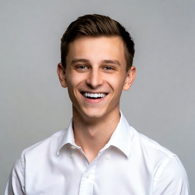 Young man smiling in white shirt