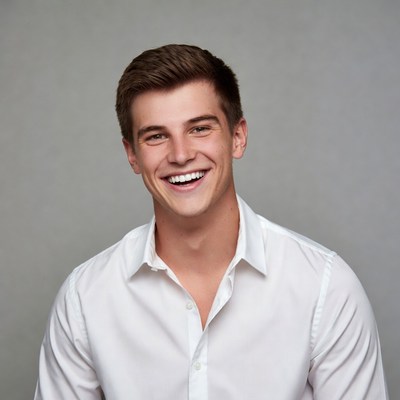Young man smiling in white shirt