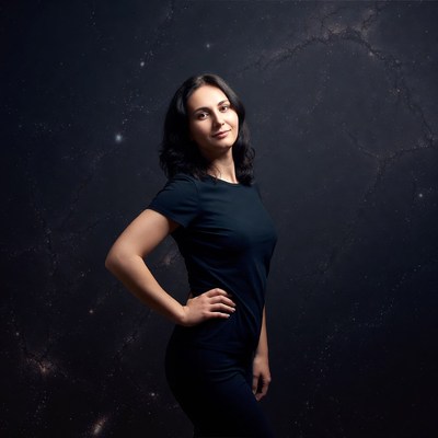 Woman posing against starry galaxy background