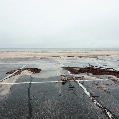 Flooded beach parking lot with debris