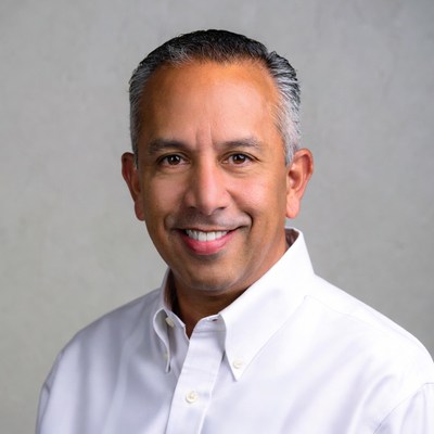 Smiling Middle Eastern man in white shirt