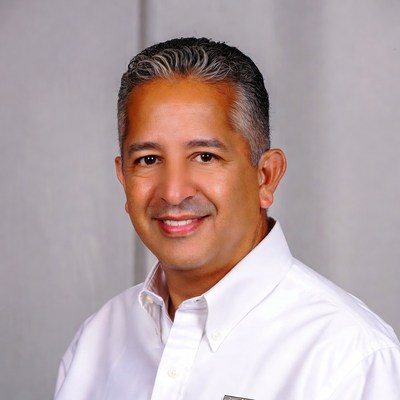 Smiling Latino man in white shirt