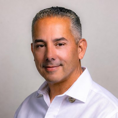 Smiling Latino man in white shirt
