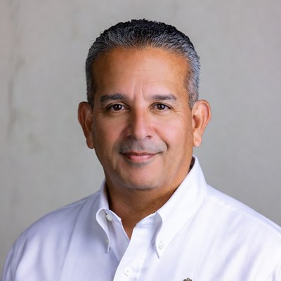 Smiling Middle Eastern man in white shirt