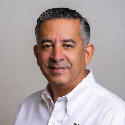 Middle-aged man smiling in white shirt