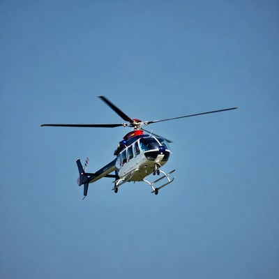 Blue and white helicopter flying