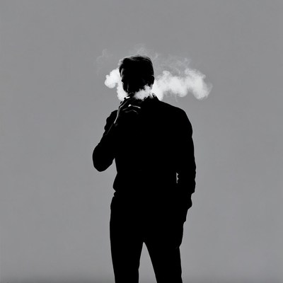 Silhouette man smoking cigarette