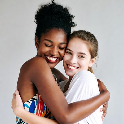 Black woman hugging white woman