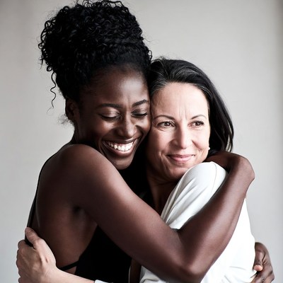 Black woman hugging White woman