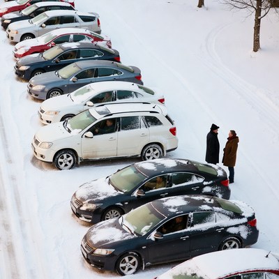 Snowy Car Park Two People Talking