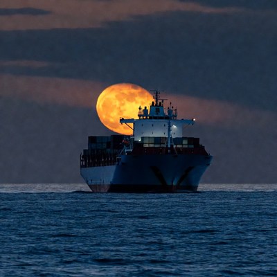 Cargo Ship with Supermoon Rising