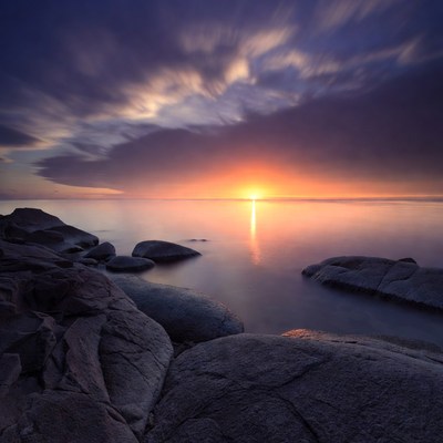 Sunset over rocky seashore