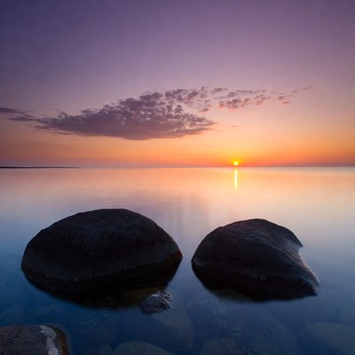 Two Rocks in Calm Lake Sunset