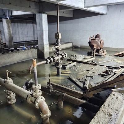 Flooded industrial basement with pipes