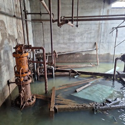 Flooded Industrial Room with Rusty Pipes