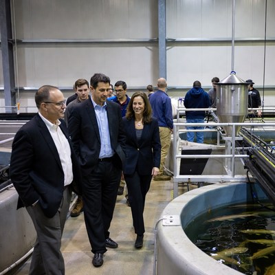 Business people touring fish farm